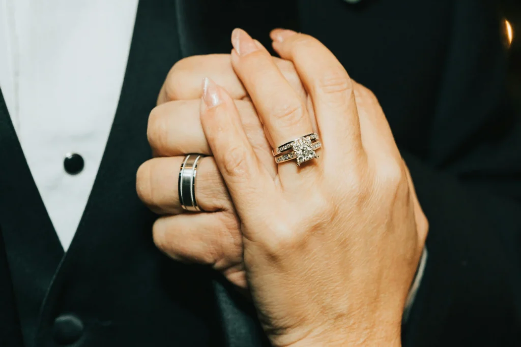husband wife romantic hand holding with white gold diamond bands