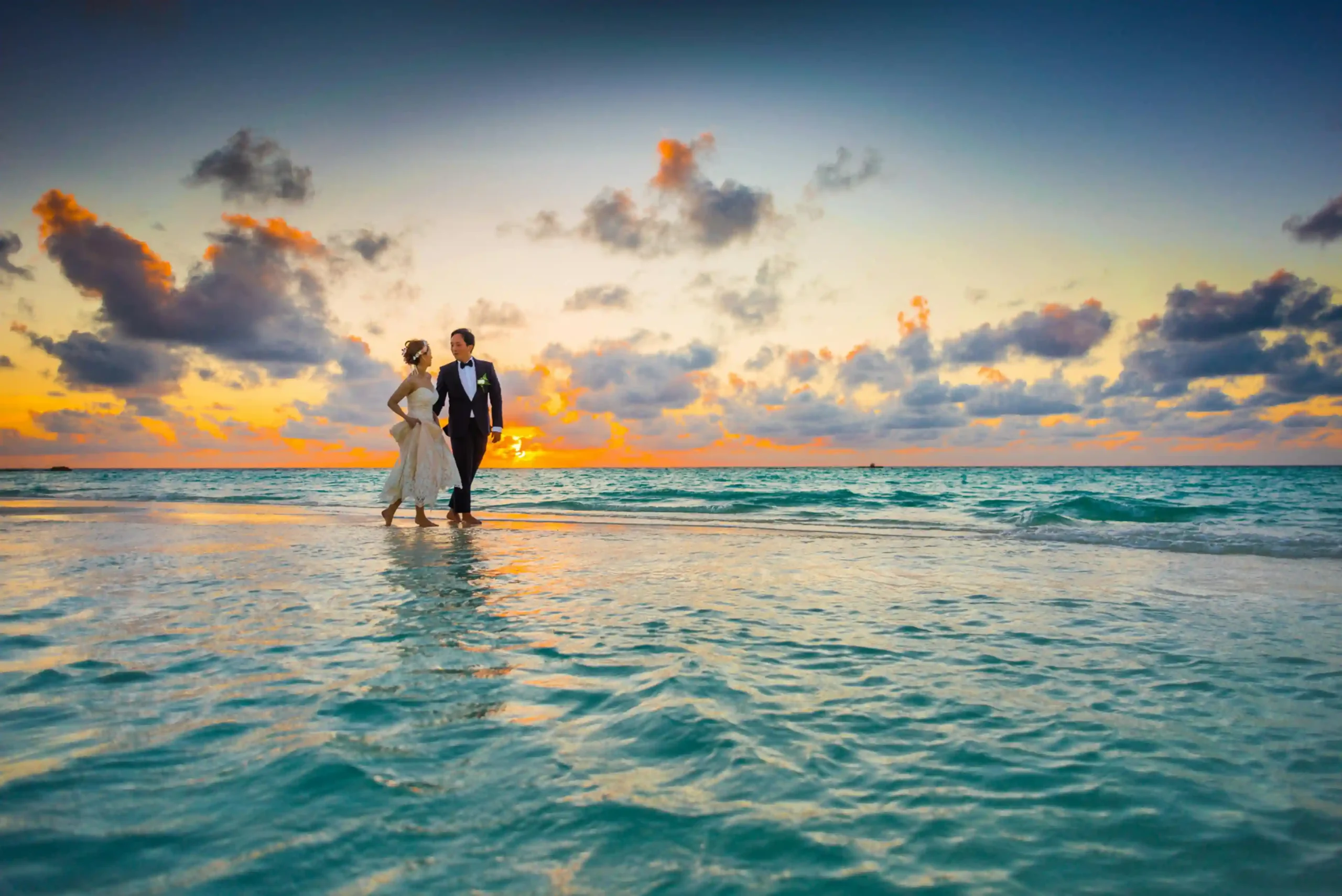 wedding dresses of couple at beach