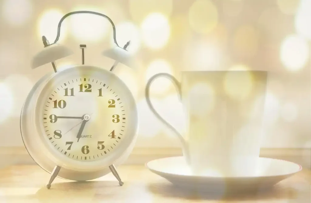 clock on table with beautiful cup