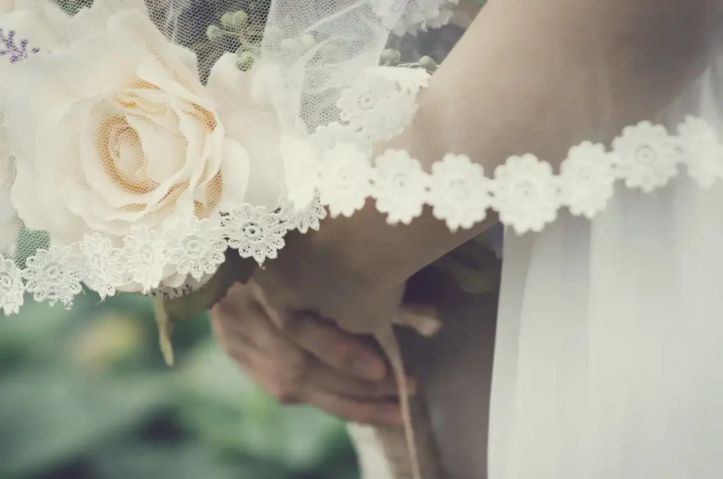 bride holding wedding corsages