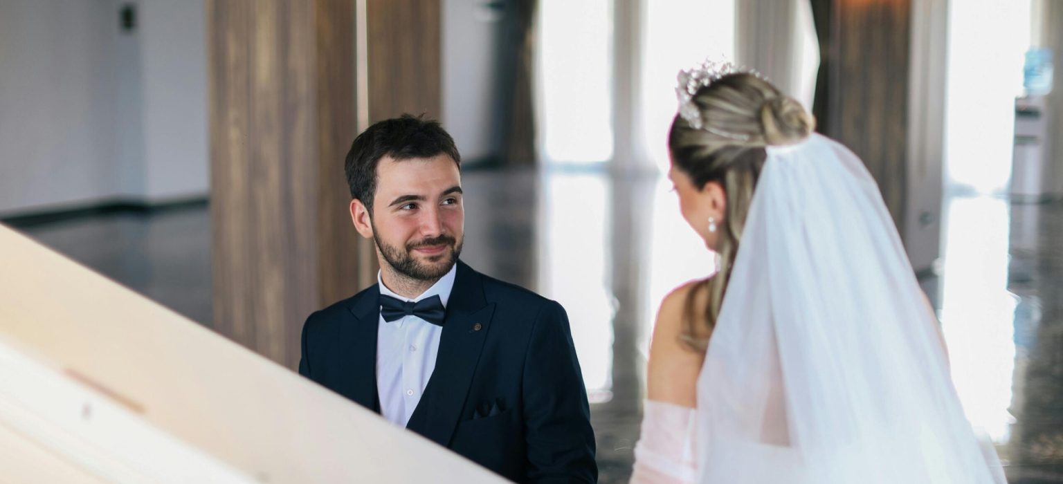 photo of a couple enjoying lovely time while groom is playing piano for her bride.